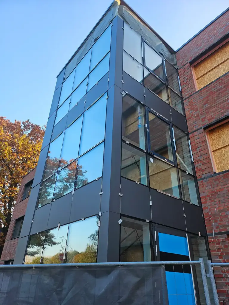 Glas- und Aluminiumfassade während der Montage an einem mehrgeschossigen Gewerbegebäude